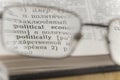 Reading glasses and an open book in close-up. Old Russian-Englis Royalty Free Stock Photo