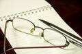 Reading glasses and pen Royalty Free Stock Photo