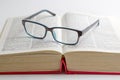 Reading glasses placed on a book