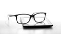 Reading glasses resting on an e-book reader Royalty Free Stock Photo
