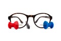 Reading glasses with tortoiseshell frames, pen and tack Royalty Free Stock Photo