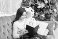 Reading is always a good idea. Little girl read book to toy friend. Small child enjoy reading xmas story. Winter reading Royalty Free Stock Photo