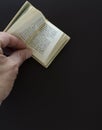 Reading greek mini book (Apology of Socrates) Royalty Free Stock Photo