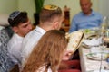 Reading the haggadah, jewish family at feast of Passover.