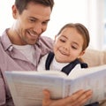 Reading her favourite story. a young father reading a book with his daughter. Royalty Free Stock Photo