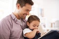 Reading her favourite story. a young father reading a book with his daughter. Royalty Free Stock Photo