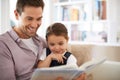 Reading her favourite story. a young father reading a book with his daughter. Royalty Free Stock Photo