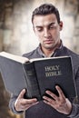 Reading and holding Holy Bible Royalty Free Stock Photo