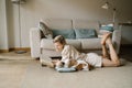 Reading at home with sleeping small dog. Royalty Free Stock Photo