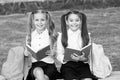 Reading is the key. Happy children read books on bench. Little girls enjoy reading outdoors. Home reading. Developing Royalty Free Stock Photo