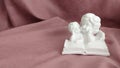 Reading a big book a white statuette of angels close-up Royalty Free Stock Photo