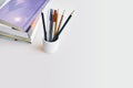 Reading, Learning, Lifestyles concept. Stacked books with cup of pencils, pens with copy space. Royalty Free Stock Photo