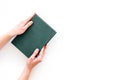 Reading for leasure. Hands take hardback book with empty cover on white background top view space for text Royalty Free Stock Photo