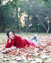 Reading in nature is my hobby, beautiful girl Read book Lying on the fallen leaves in autumn park Royalty Free Stock Photo