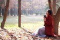 Reading in nature is my hobby,Girl with book and tea in the autumn park Royalty Free Stock Photo