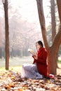 Reading in nature is my hobby,Girl with book and tea in the autumn park Royalty Free Stock Photo