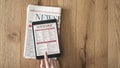 Reading news on tablet and newspaper on wooden background