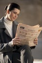 Reading newspaper outdoors Royalty Free Stock Photo