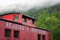 Reading & Northern red train car against foggy mountainside