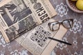 Reading old Soviet newspapers, vintage glasses