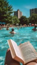 Reading at the poolside, a person escapes the heatwave. Leisure in extreme summer temperatures