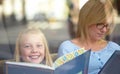 Reading, portrait and mother with child in bookshop with smile, learning and relax in knowledge. Storytelling, happy mom Royalty Free Stock Photo