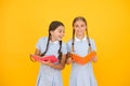 Reading and retelling. Small children holding books yellow background. Sincere interest. Little girls with encyclopedia Royalty Free Stock Photo