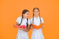 Reading and retelling. Small children holding books yellow background. Sincere interest. Little girls with encyclopedia Royalty Free Stock Photo