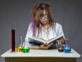 Reading serious scientist with glass flask