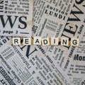 Reading sign of English learning skills written on vintage sheets of newspaper. Square instagram format