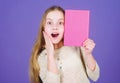 Reading skill. Personal diary. Textbook presentation. Study and learn. Girl hold book violet background. Kid show book