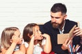 Reading a story. father read book to his daughters. Royalty Free Stock Photo