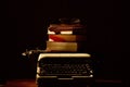Reading, storytelling and education. Concept for writing, writer and fiction. A typewriter and a stack of books.