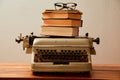 Reading, storytelling and education. Concept for writing, writer and fiction. A typewriter and a stack of books.