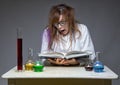 Reading surprised scientist with glass flask