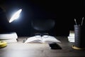 Reading table at night, Open books and glasses placed, Book Division and lighting lamps Royalty Free Stock Photo
