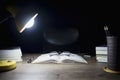 Reading table at night, Open books and glasses placed, Book Division and lighting lamps Royalty Free Stock Photo