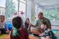 Reading time in an elementary school or kindergarten, a teacher reading a book to children in an elementary school or Royalty Free Stock Photo