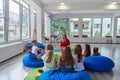 Reading time in an elementary school or kindergarten, a teacher reading a book to children in an elementary school or Royalty Free Stock Photo