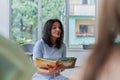 Reading time in an elementary school or kindergarten, a teacher reading a book to children in an elementary school or Royalty Free Stock Photo