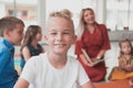 Reading time in an elementary school or kindergarten, a teacher reads a book to children in an elementary school or Royalty Free Stock Photo