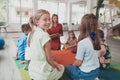 Reading time in an elementary school or kindergarten, a teacher reads a book to children in an elementary school or Royalty Free Stock Photo