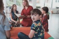 Reading time in an elementary school or kindergarten, a teacher reads a book to children in an elementary school or Royalty Free Stock Photo