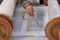 Reading the Torah scroll with a silver yad or pointer Royalty Free Stock Photo