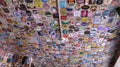 Variety of beer coasters adorn walls and ceiling in English pub