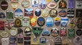 Variety of beer coasters adorn walls and ceiling in English pub