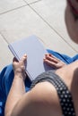 unrecognizable woman holding blank magazine for mockup design, sitting by the swimming pool Royalty Free Stock Photo