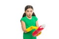 Reading washing instruction for using household cleaning product. Small child holding laundry detergent. Cute cleaner