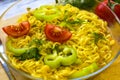 Ready noodles with vegetables and herbs on a wooden board.