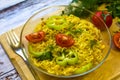 Ready noodles with vegetables and herbs on a wooden board.